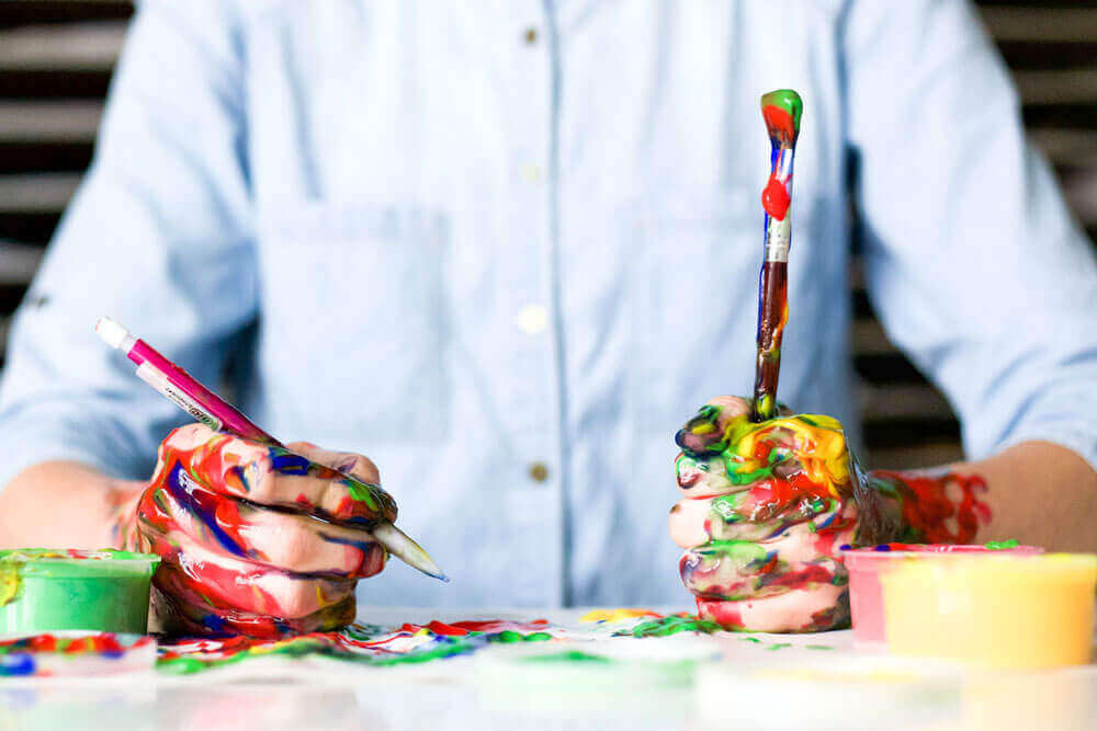 Hands covered in paint