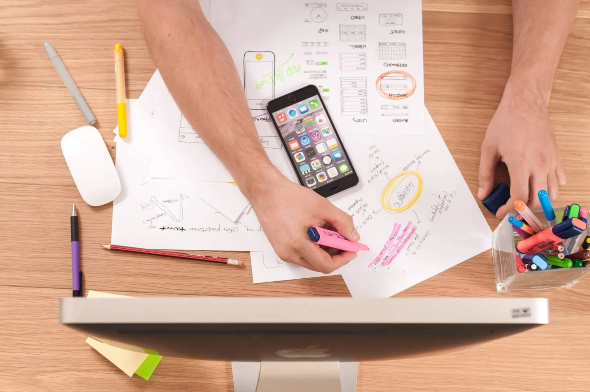 Desk with notes, computer and phone
