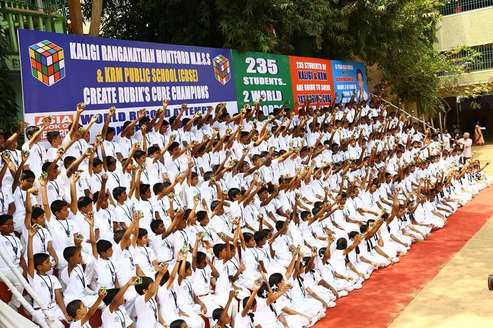 Hundreds of students at Kaligi Ranganathan Montford school raising their hands for a group photo