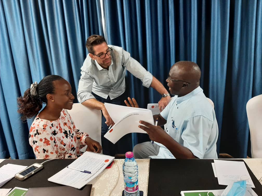 A Treehouse coach working with participants on the MSU design thinking programme in Uganda